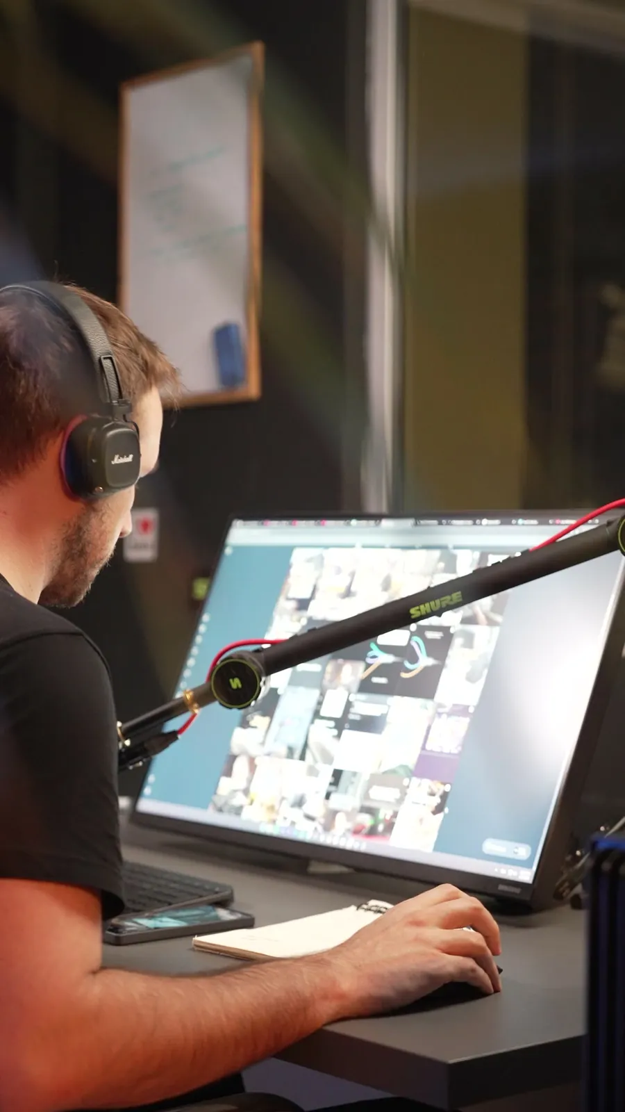 Luka at his desk in headphones, a screen full of reels in front of him